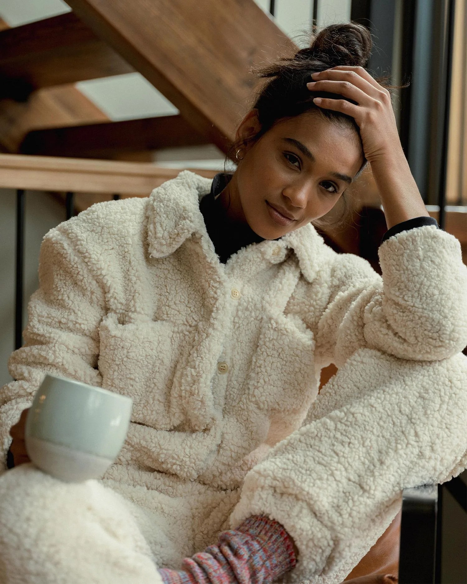 woman wearing sherpa holding mug