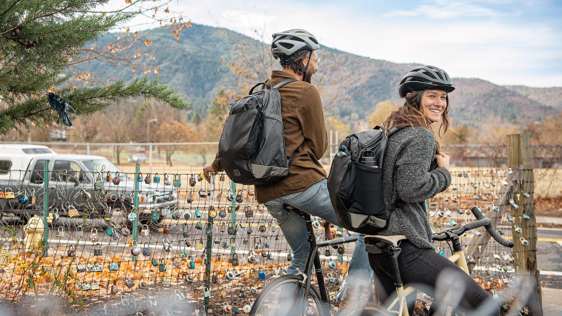 man and woman wearing camelbak backpack