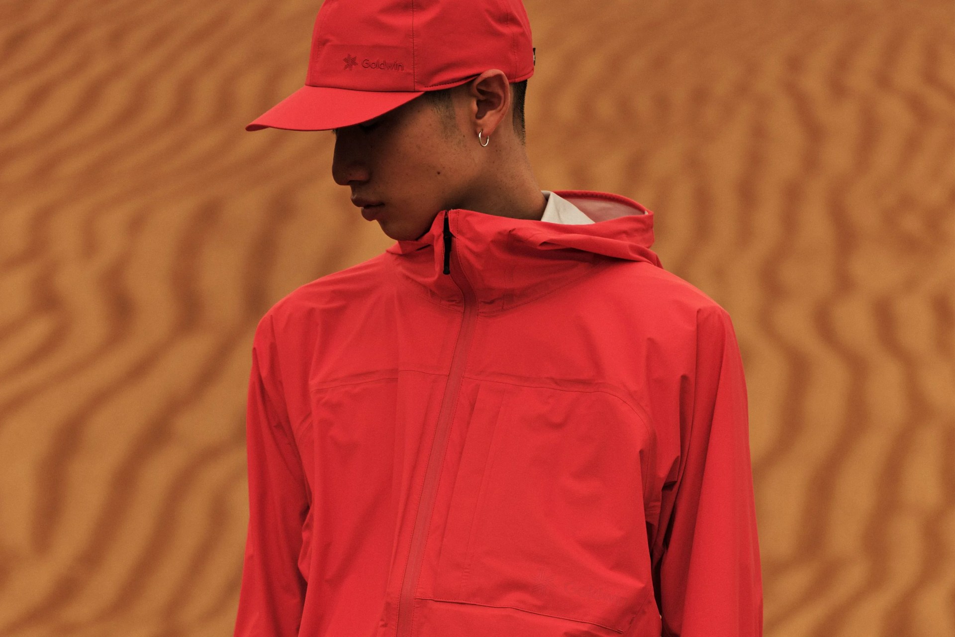 man wearing goldwin red jacket