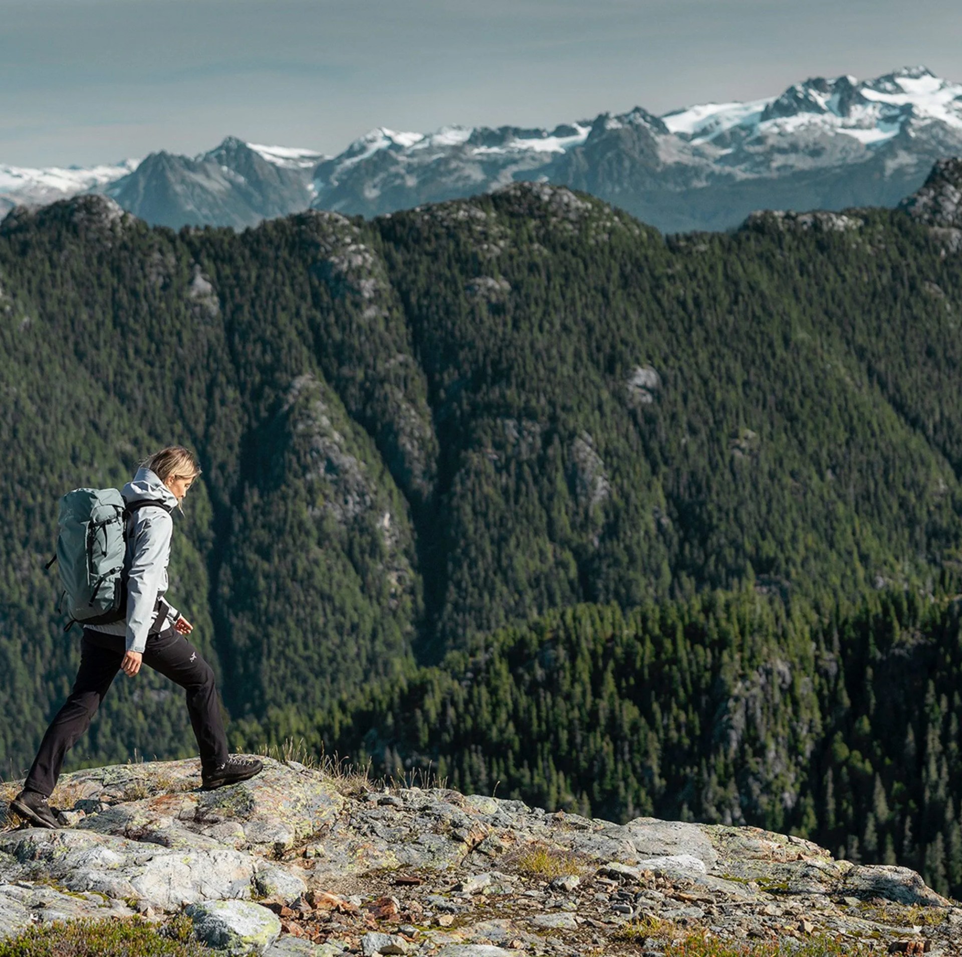 man hiking in mountains wearing arc'teryx gear
