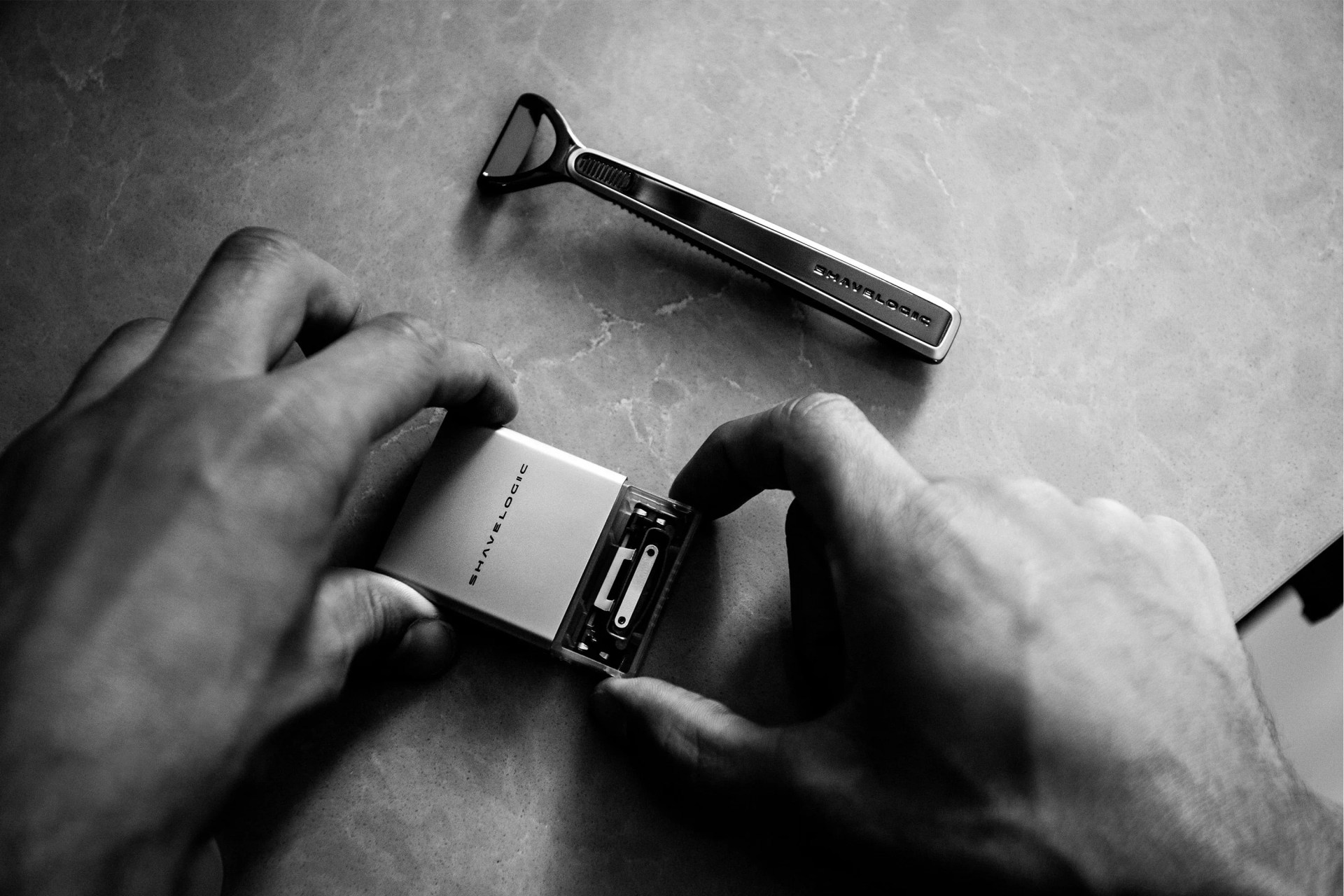 hands pulling out new razor heads