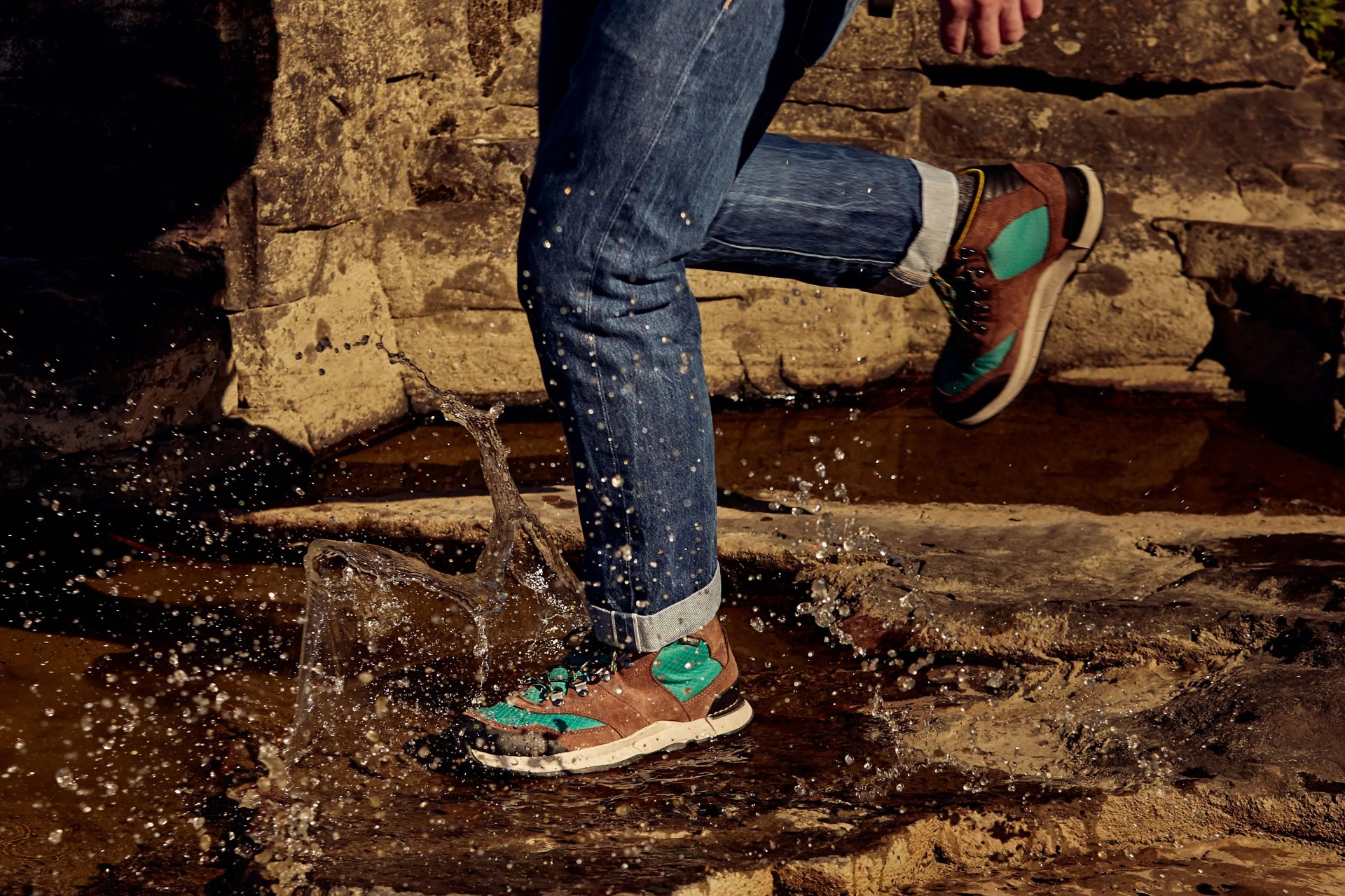 man stepping in puddle wearing danner shoes