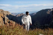 man hiking on hill