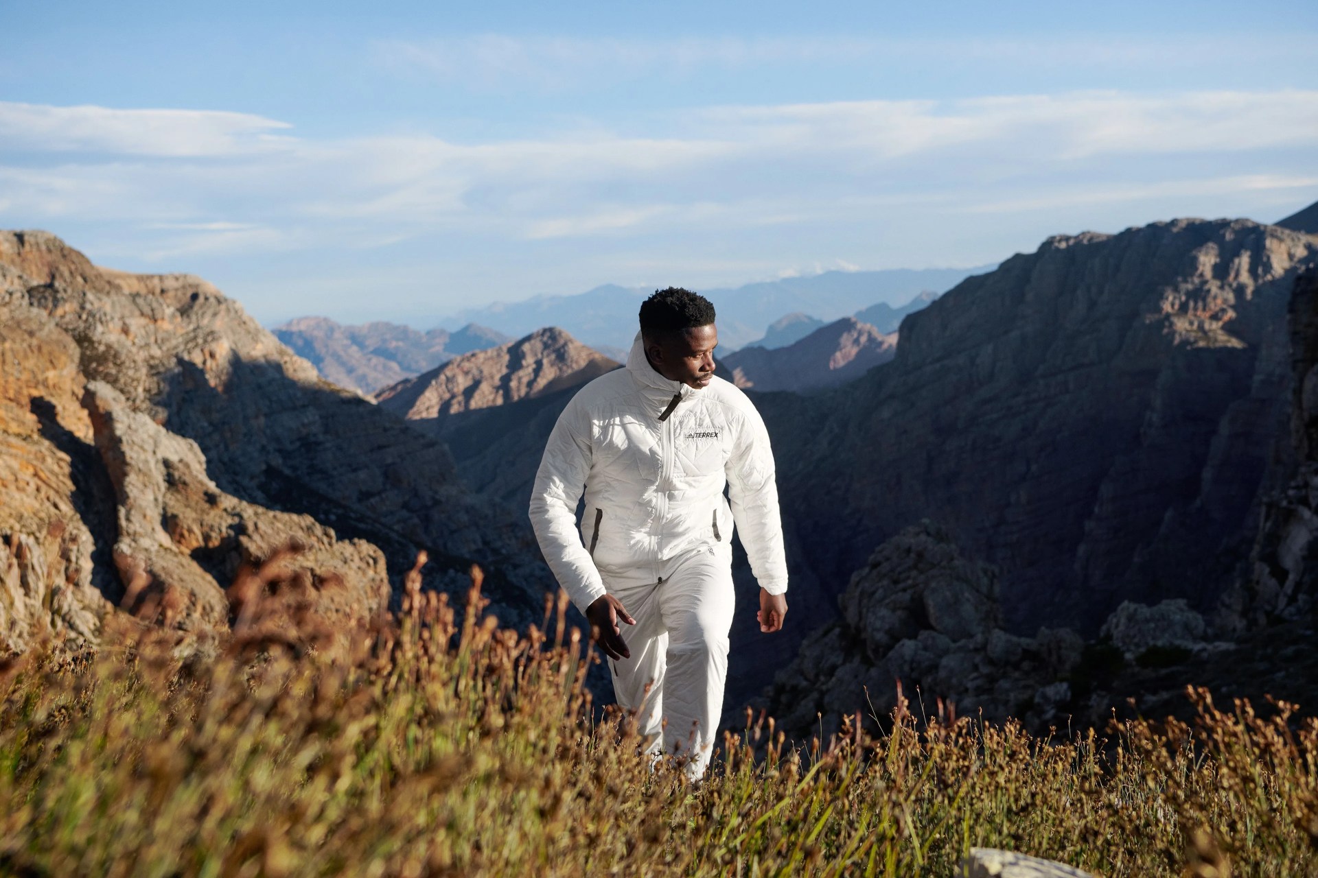 man hiking on hill