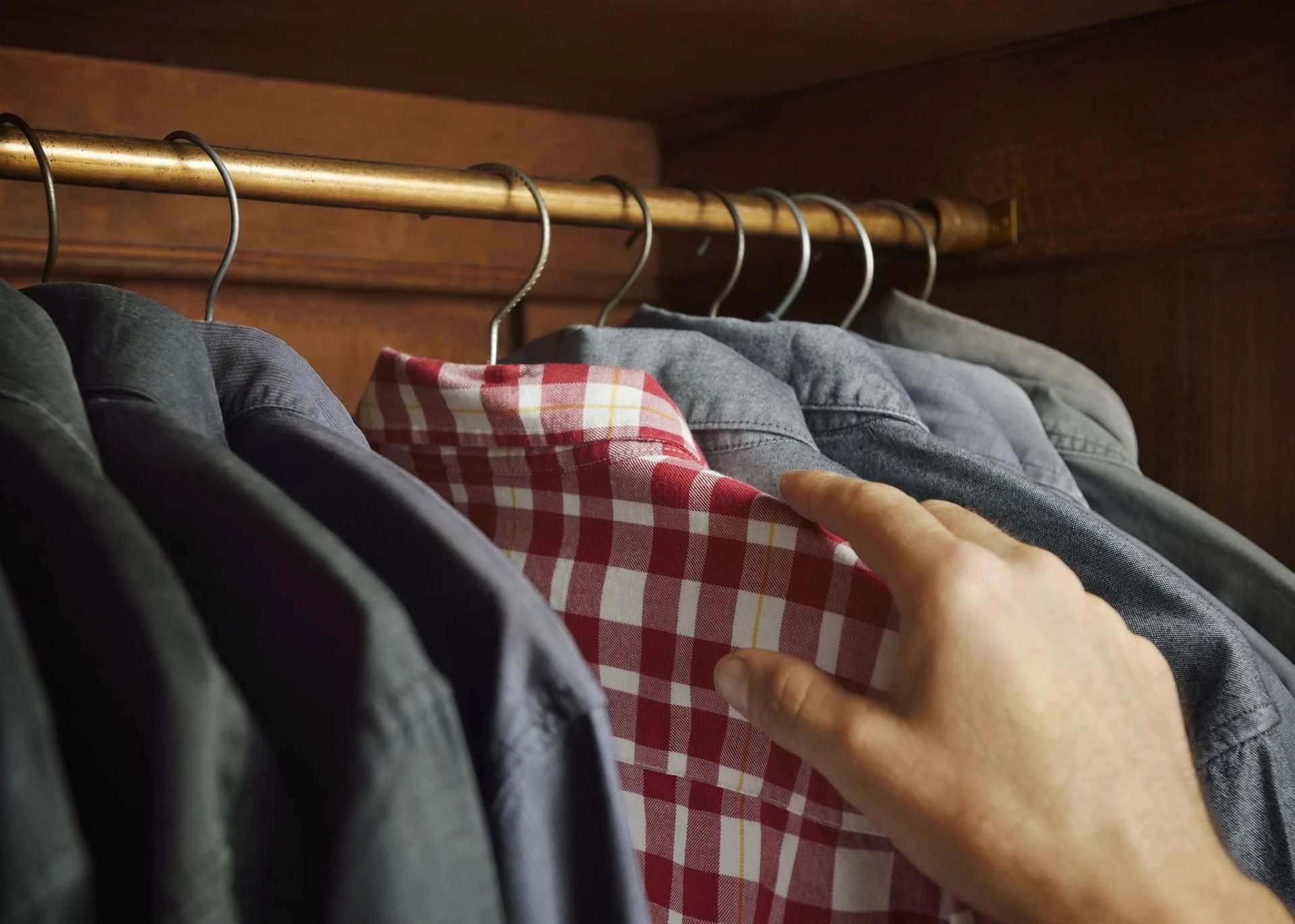 checked shirt being selected over grey shirts