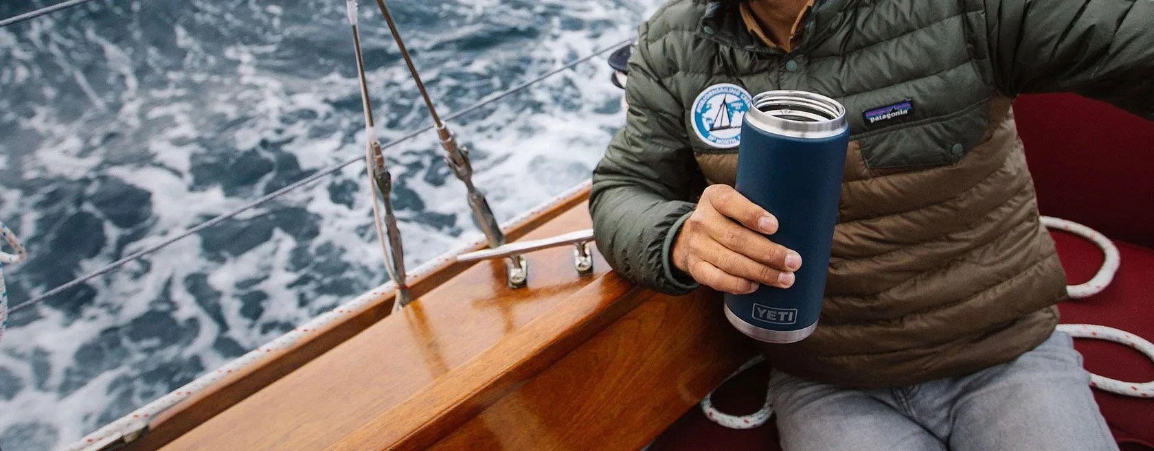 man sailing with yeti rambler