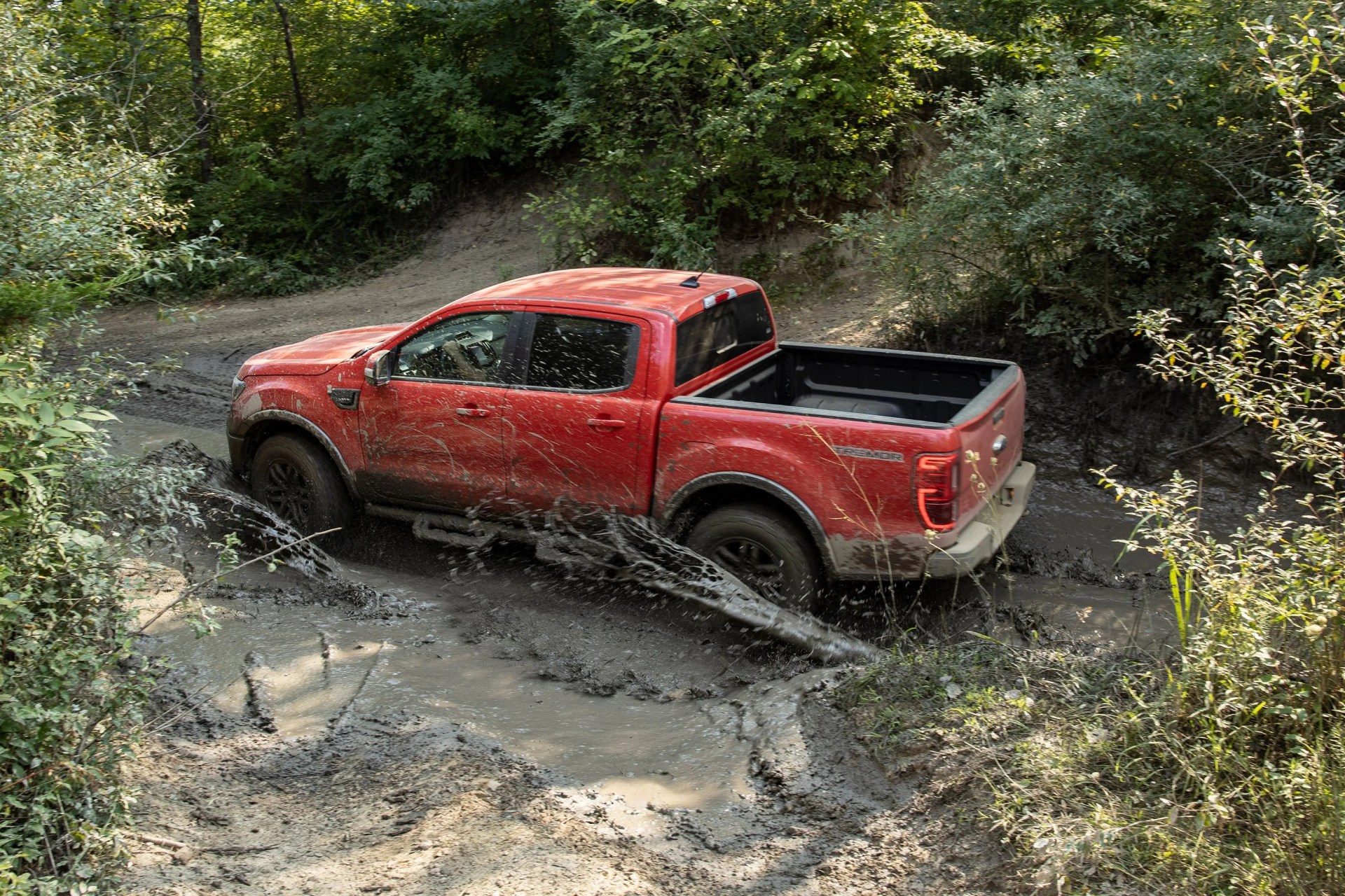 ford ranger driving through mud