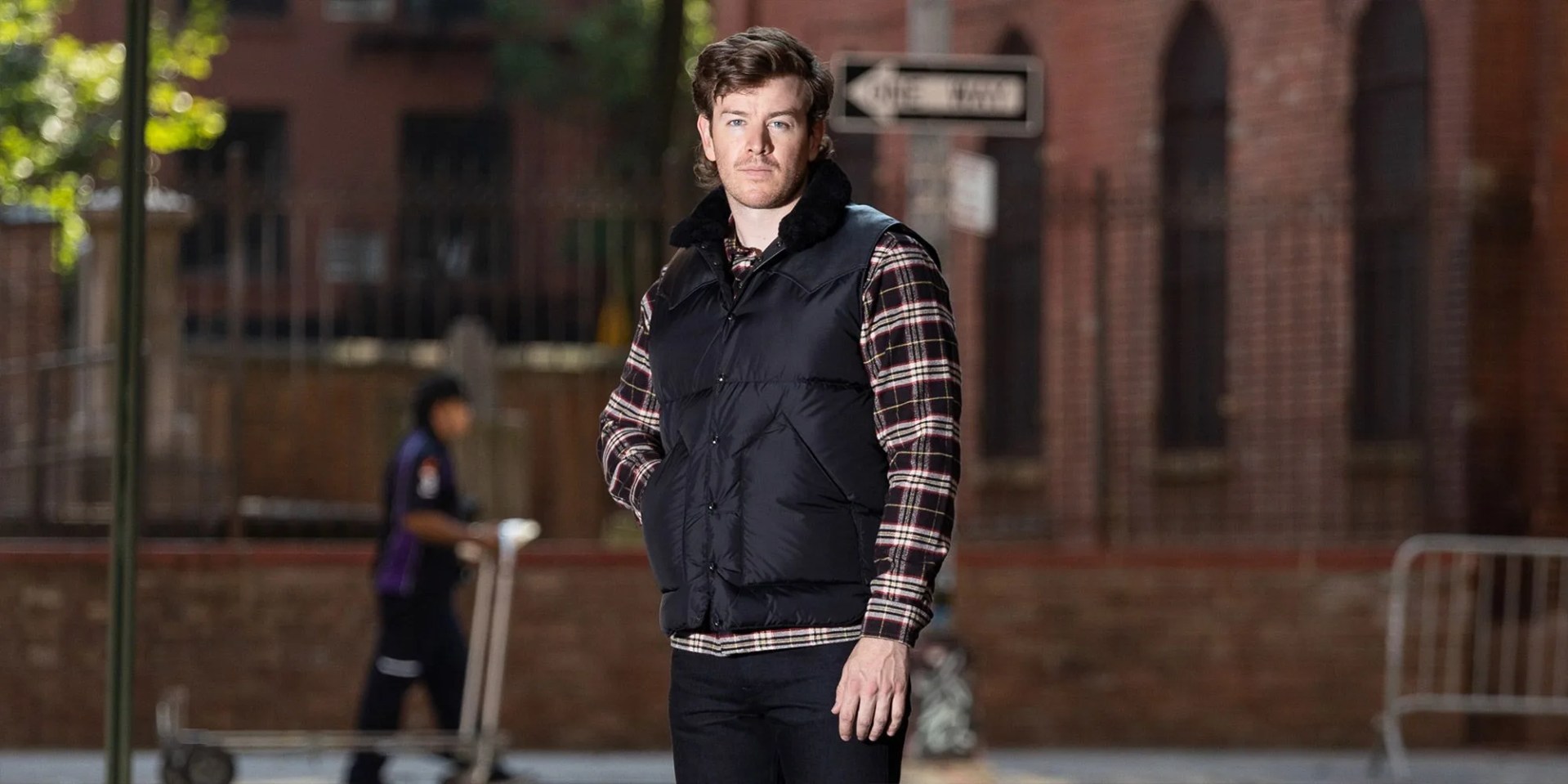 man wearing standard and strange black vest
