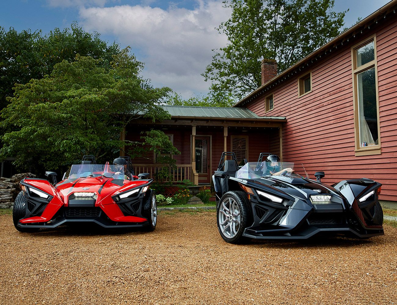 2021 polaris slingshot black car and red car