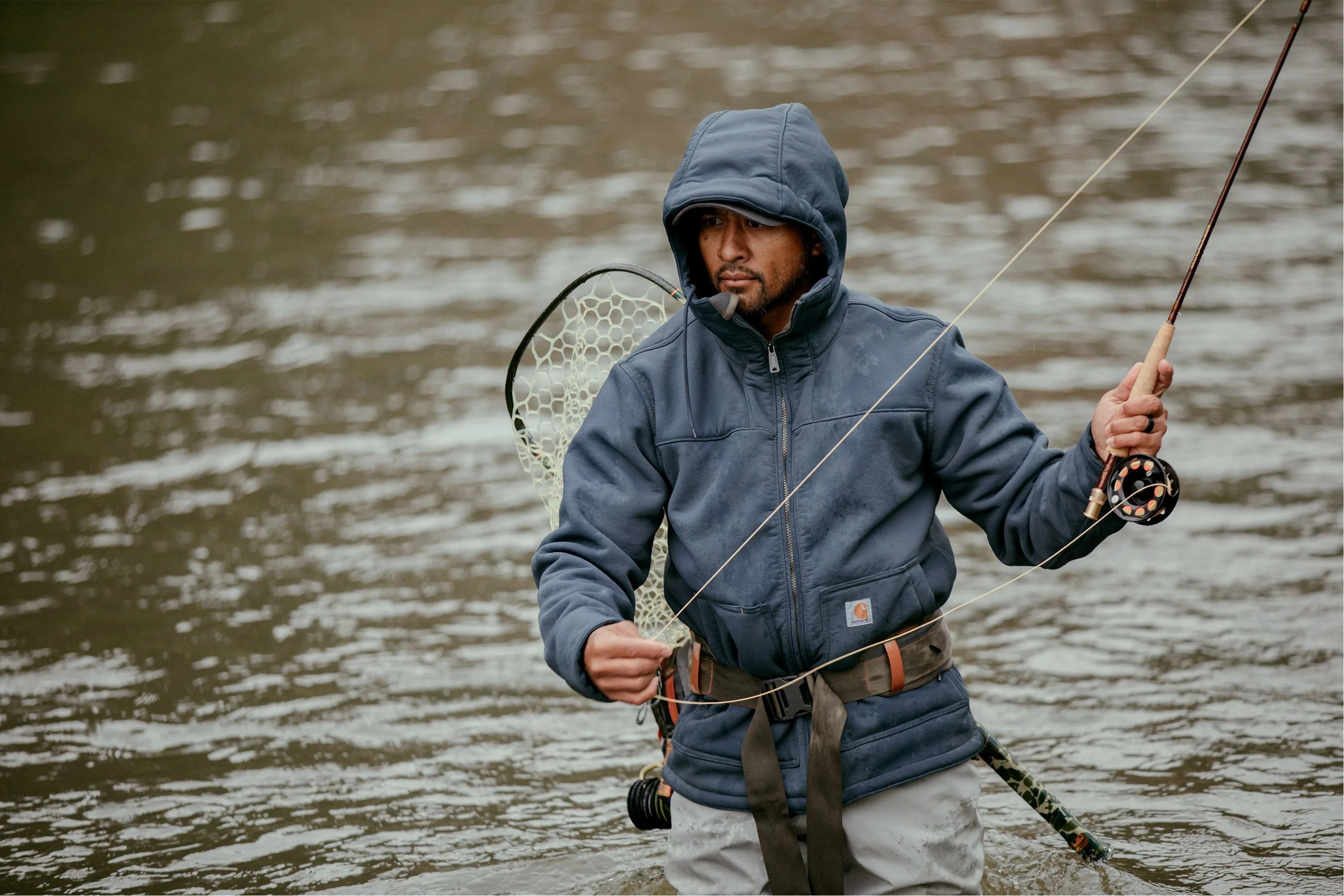 man fishing wearing carhartt blue jacket