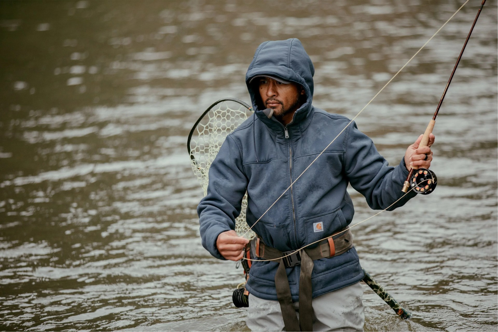 man fishing wearing carhartt blue jacket
