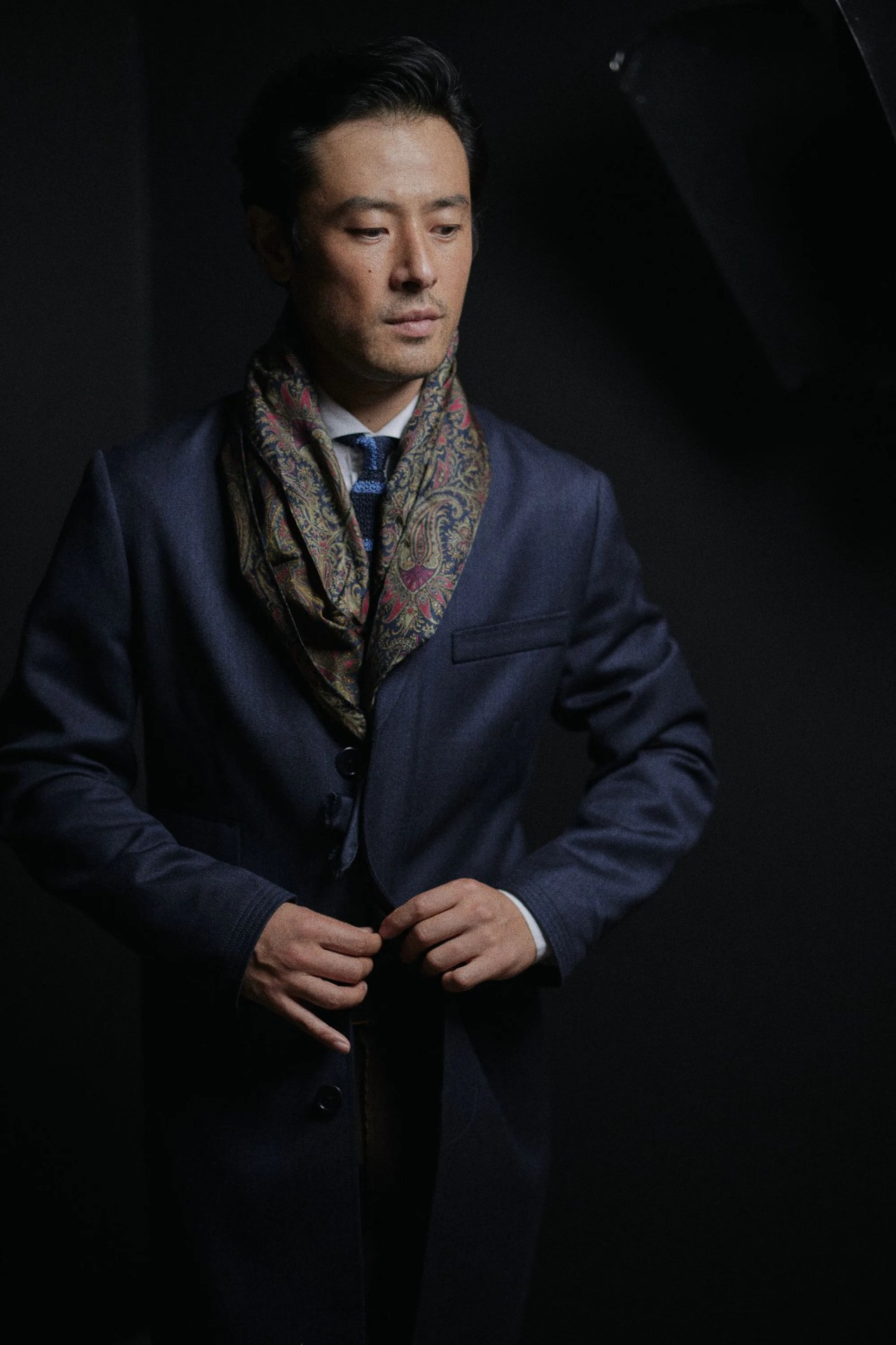 man buttoning suit