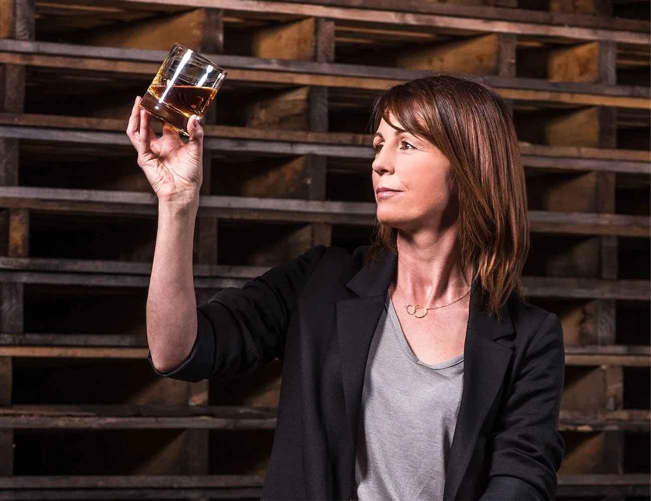 alex thomas holding a glass of whiskey