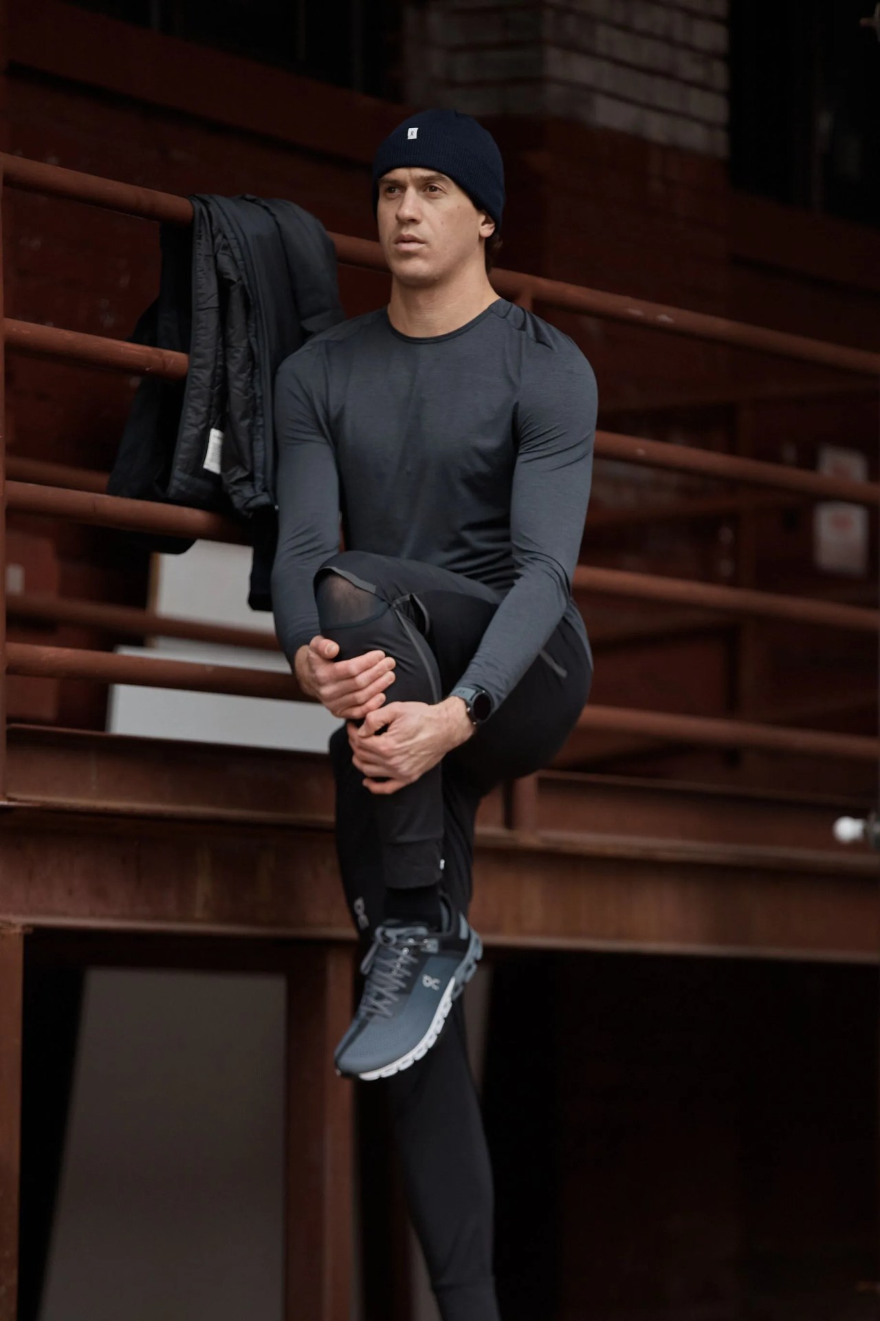 man stretching wearing on running gear