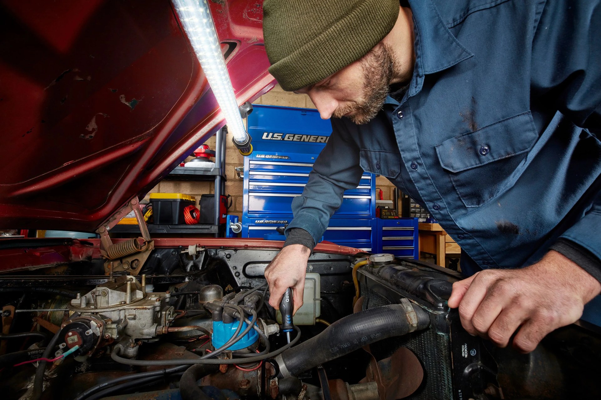 man fixing car