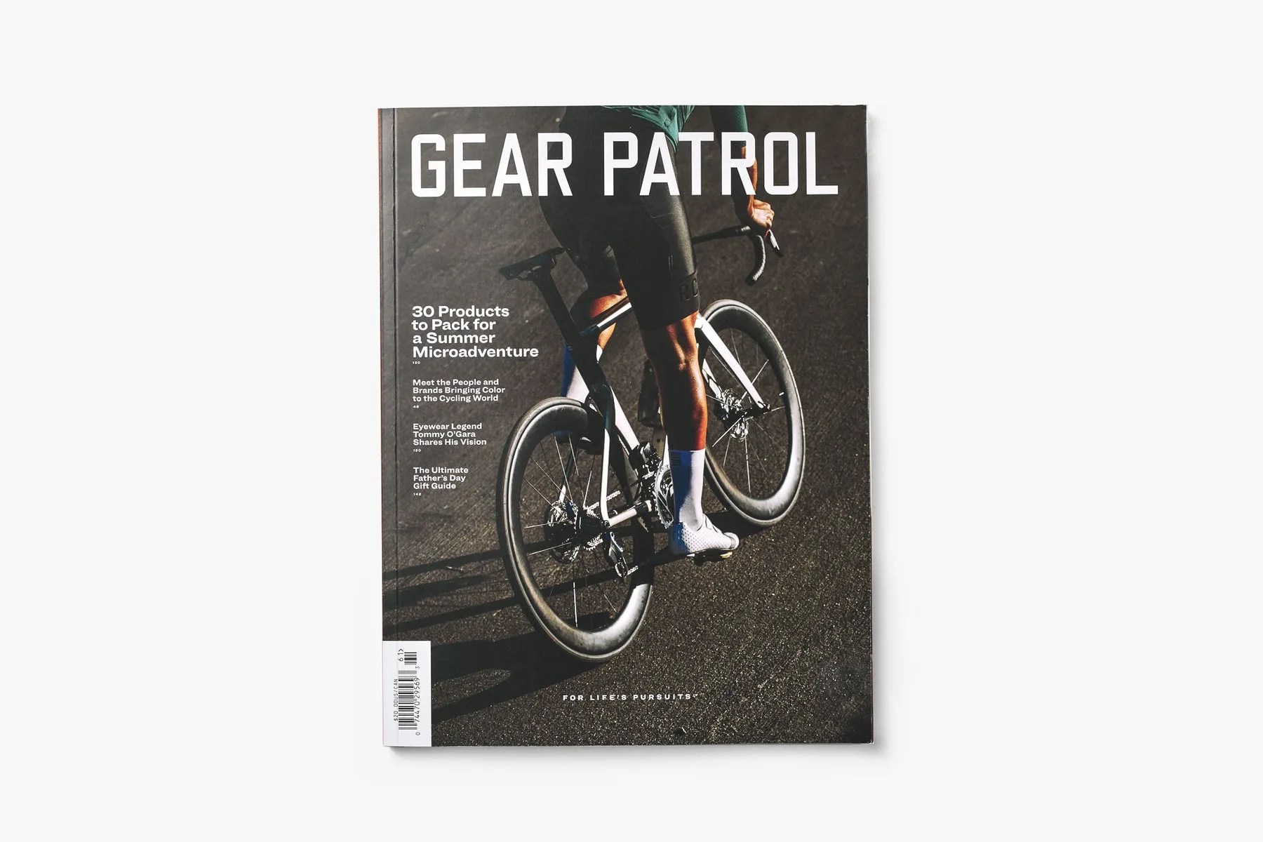 cover shot of Gear Patrol Magazine: Issue Sixteen with a man riding a bicycle on the cover