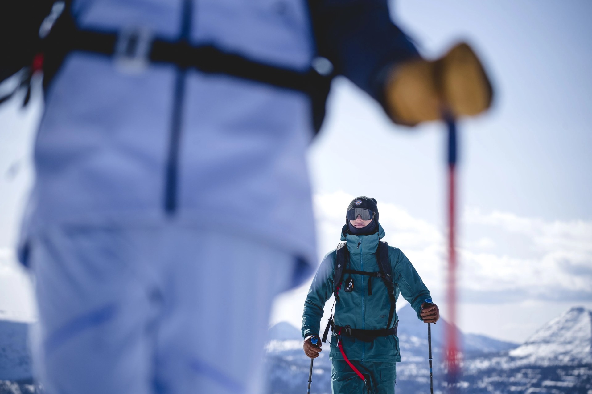 two people walking on a snowy mountain