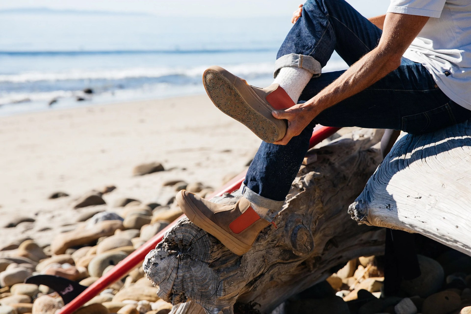 seavees shoe being taken off by beachside