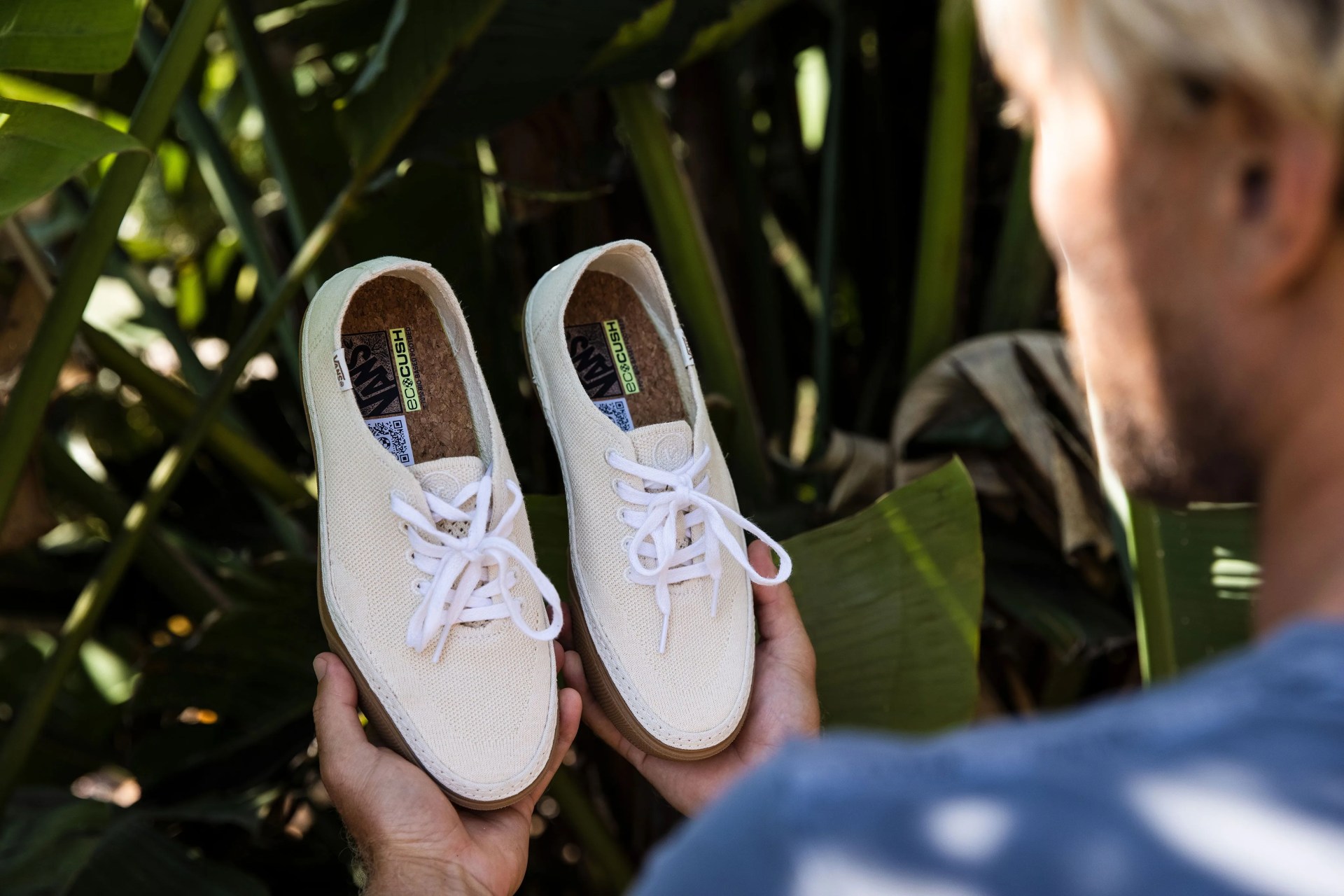 man holding vans shoes