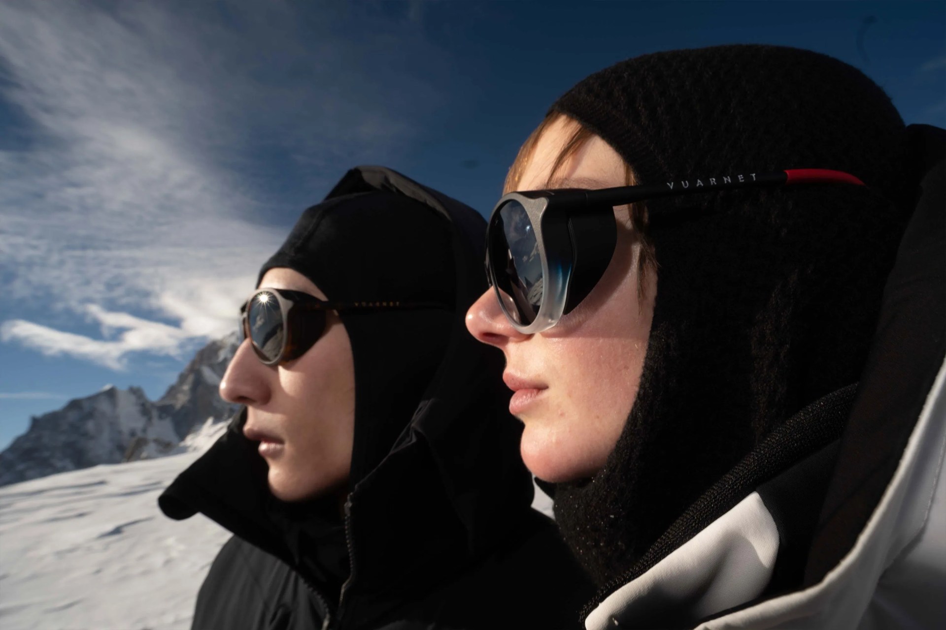 two individuals wearing vuarnet sunglasses on snowy mountain