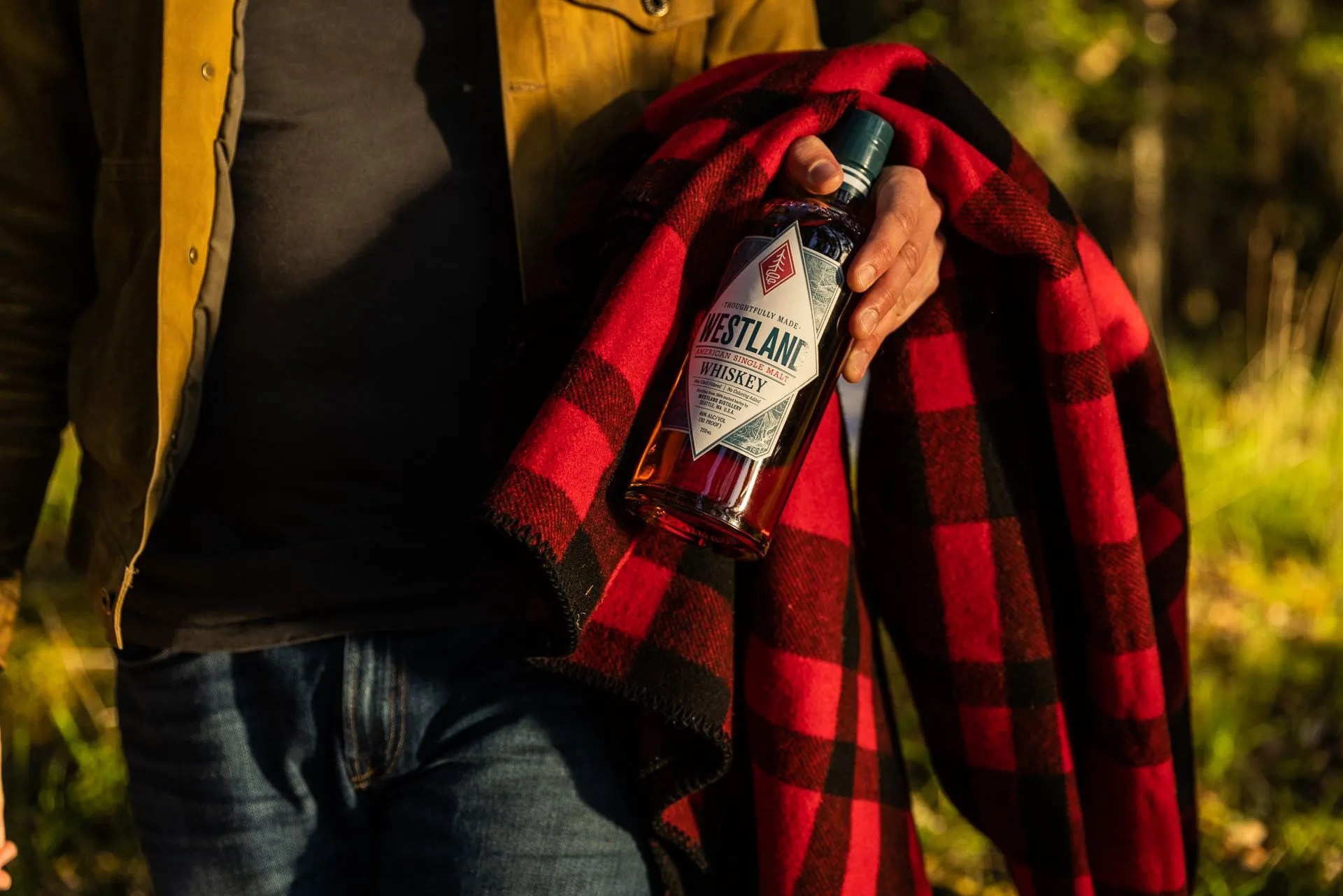 man holding westland whiskey