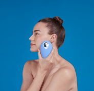 woman holding droplette facial mister up to her face