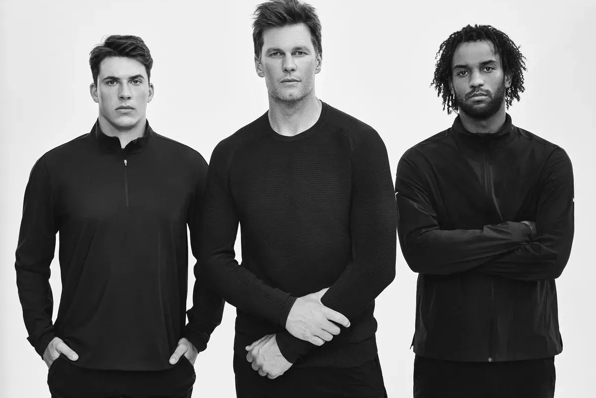 tom brady modeling his clothing with two others