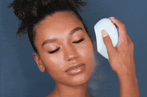 women using droplette microinfusion mister on face