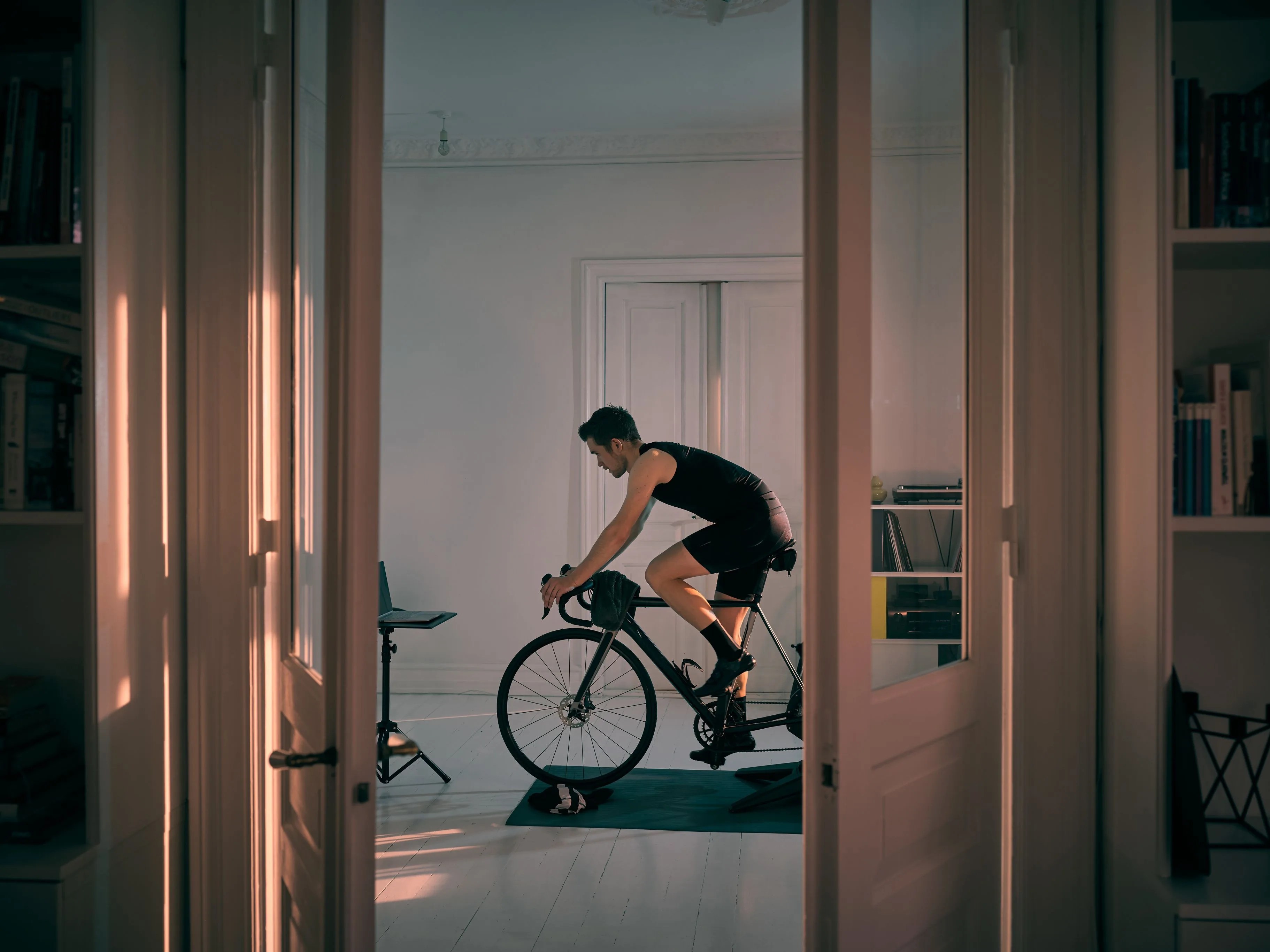 shot of a young man working out on an exercise bike at home