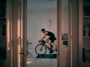 shot of a young man working out on an exercise bike at home
