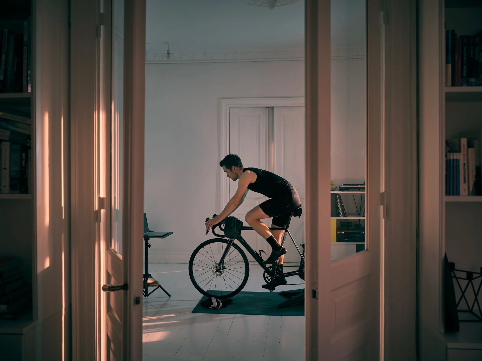 shot of a young man working out on an exercise bike at home