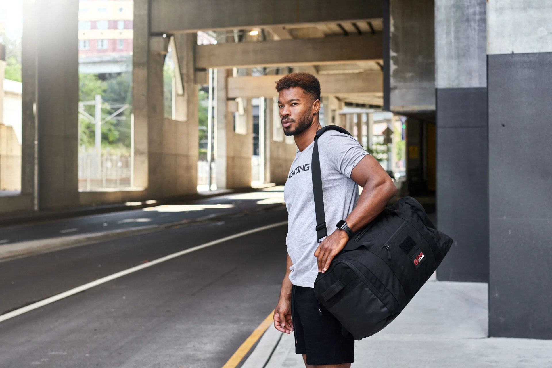 man carrying king kong apparel duffel bag