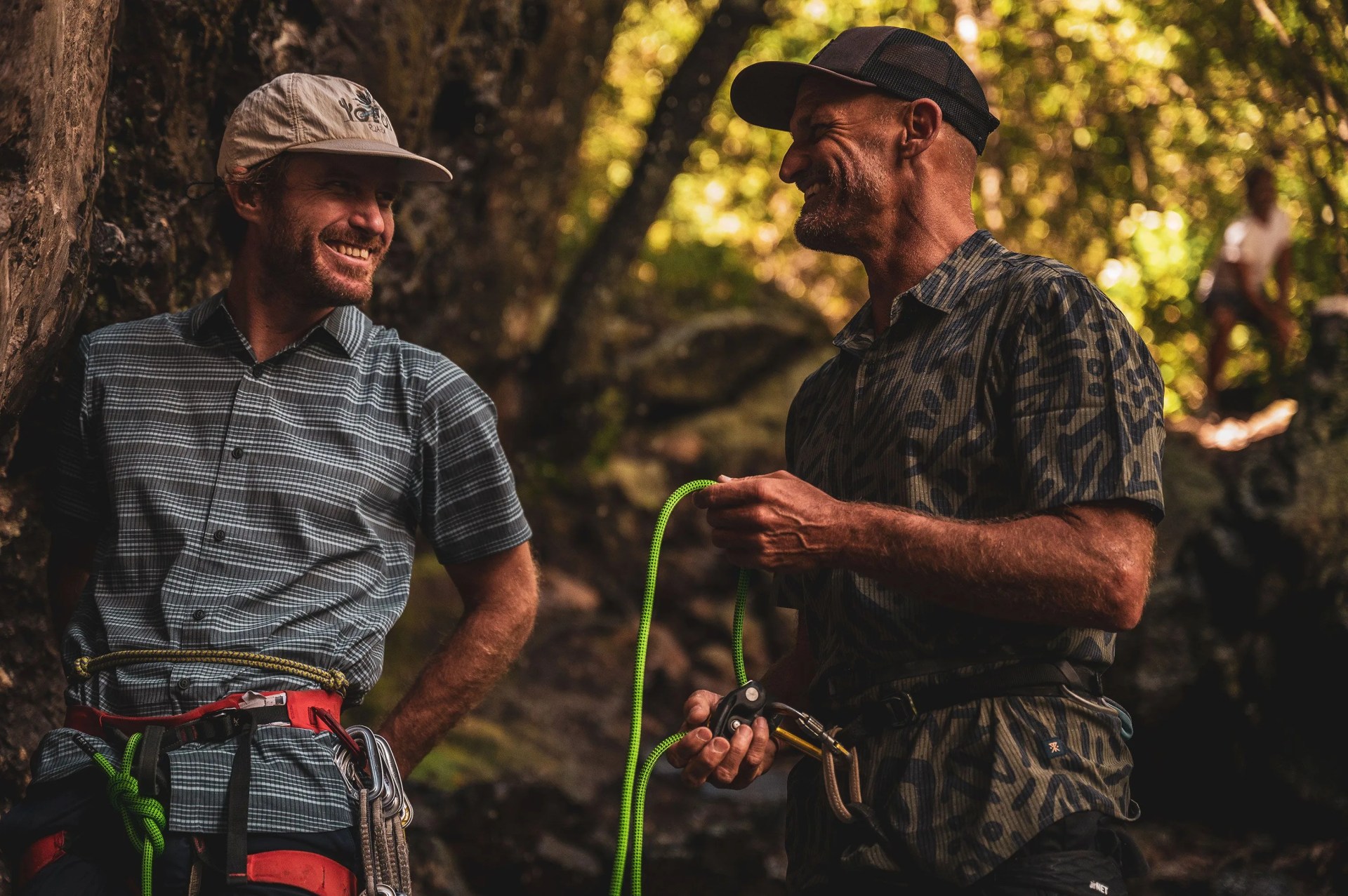 two men wearing roark gear chatting with each other in the forrest