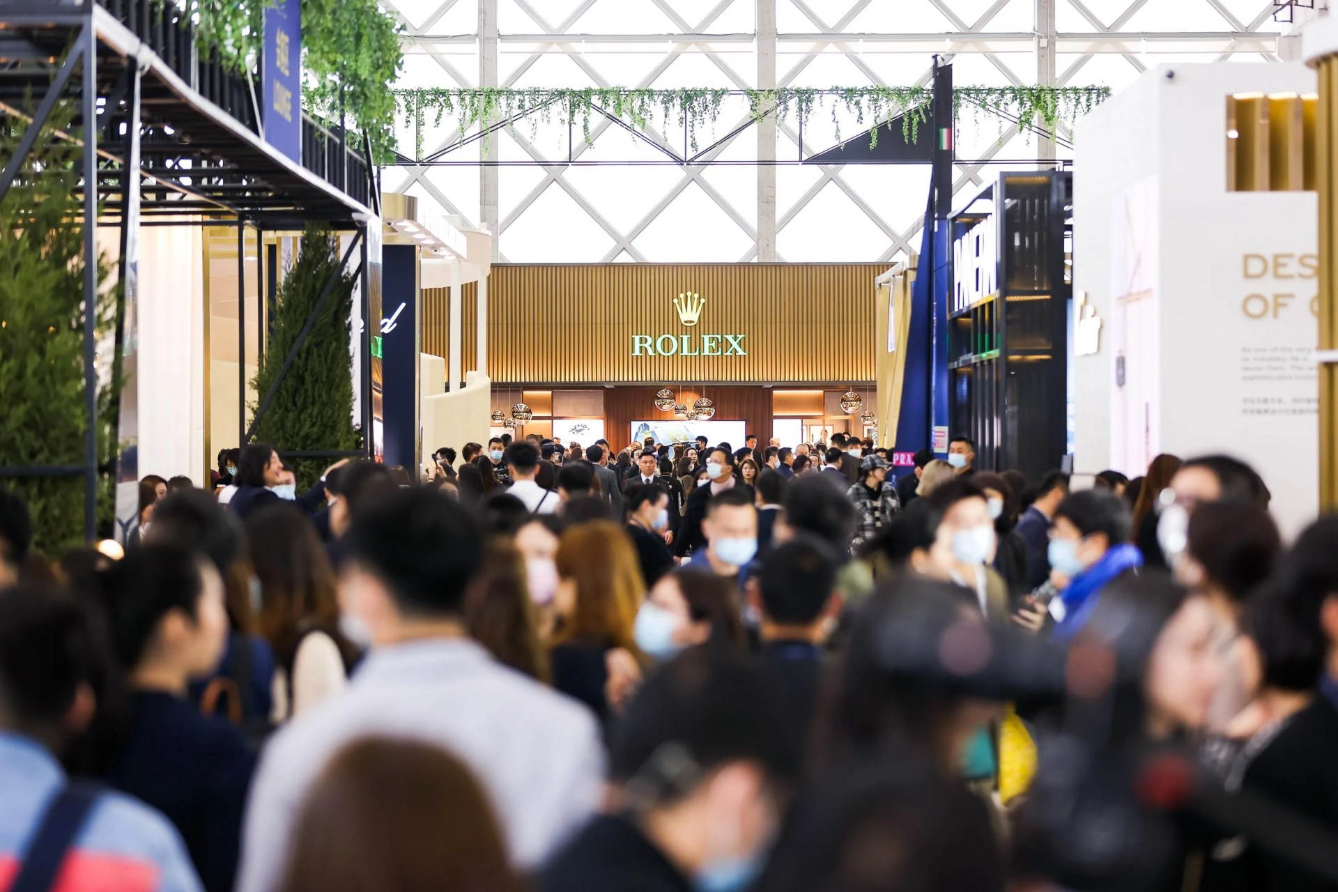watches and wonders people walking around in front of the rolex booth