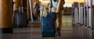 a person wheeling a yeti suitcase through an airport
