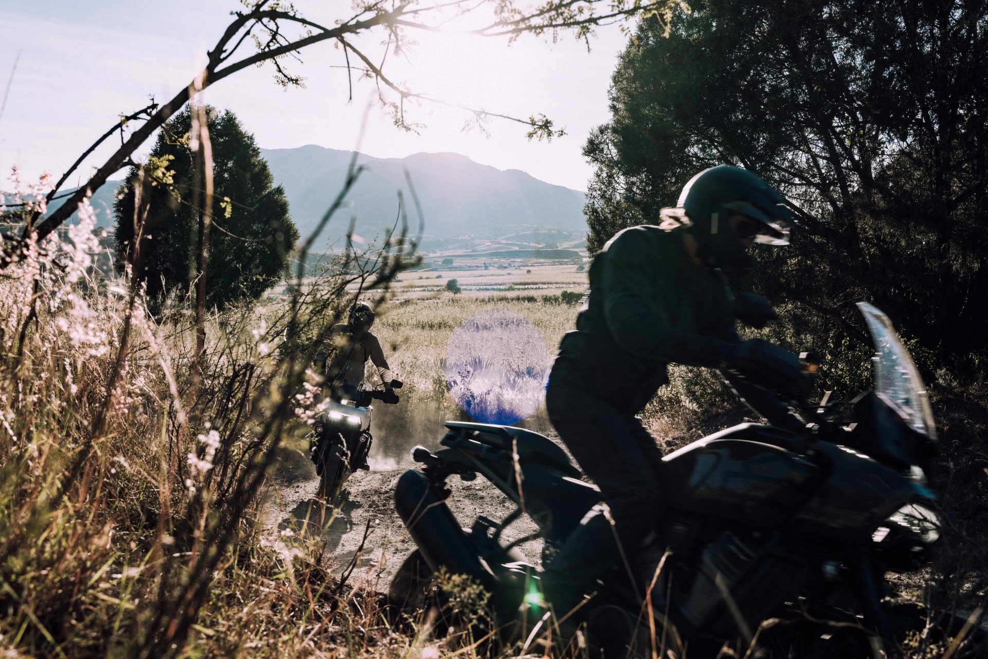 motorcyclists riding in the dirt road