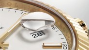 A close up of the Rolex Cyclops date widow on a gold Rolex Datejust with a white face