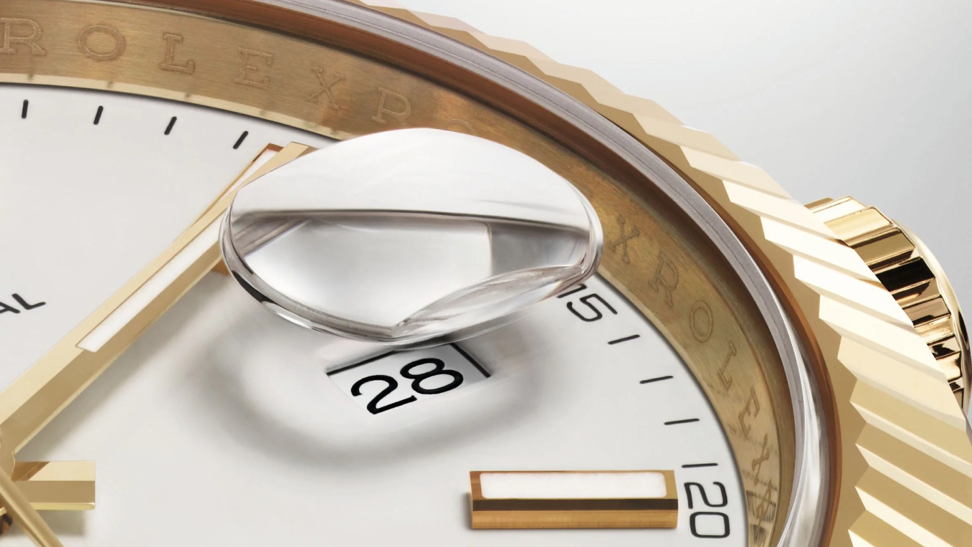 A close up of the Rolex Cyclops date widow on a gold Rolex Datejust with a white face