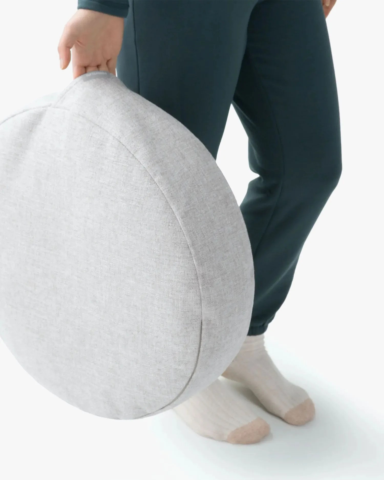 person holding tuft and needle essential dog bed