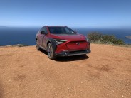 subaru solterra on a mountain top overlooking the ocean