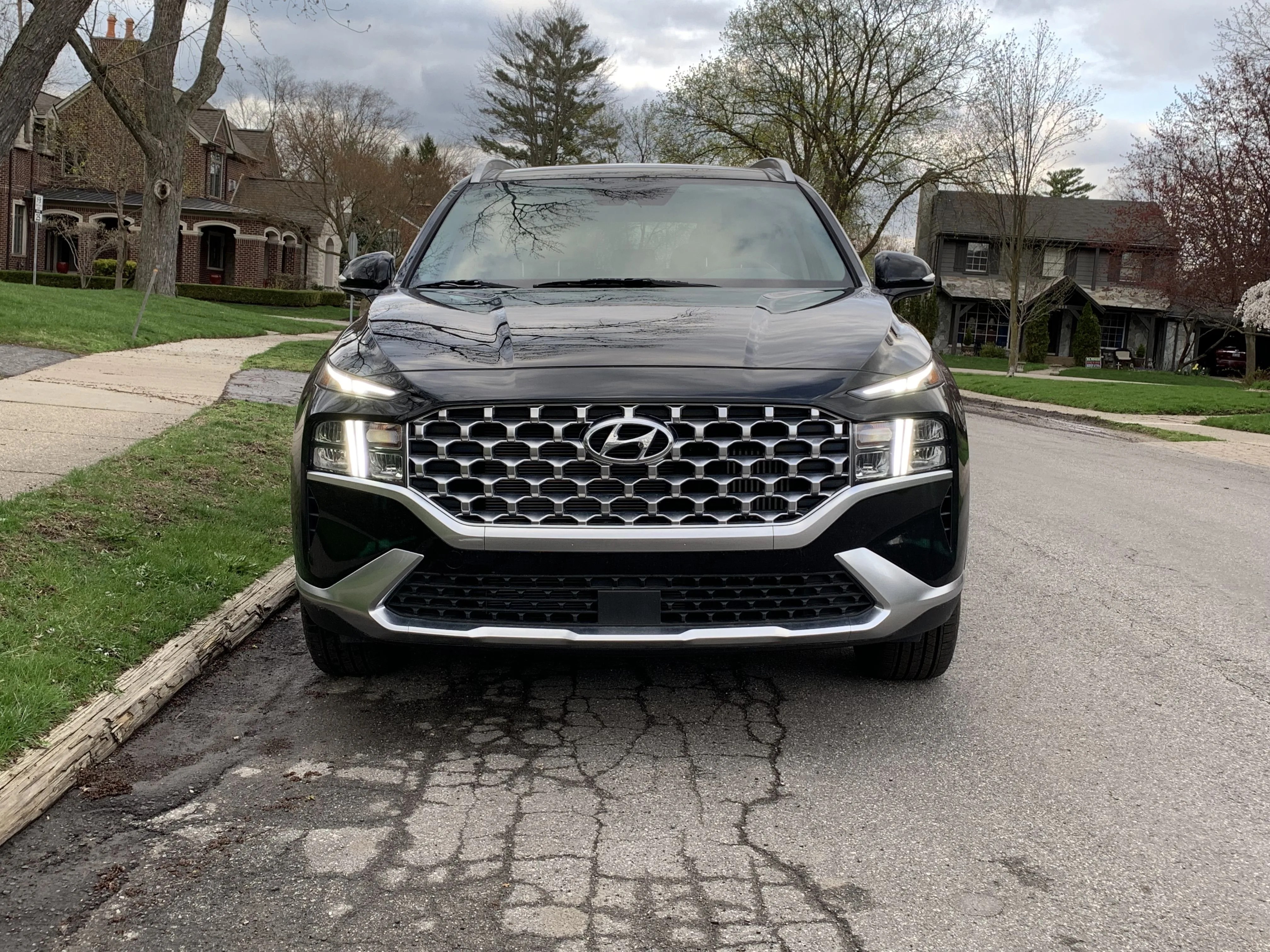 front grille of hyundai santa fe hybrid parked on suburban street