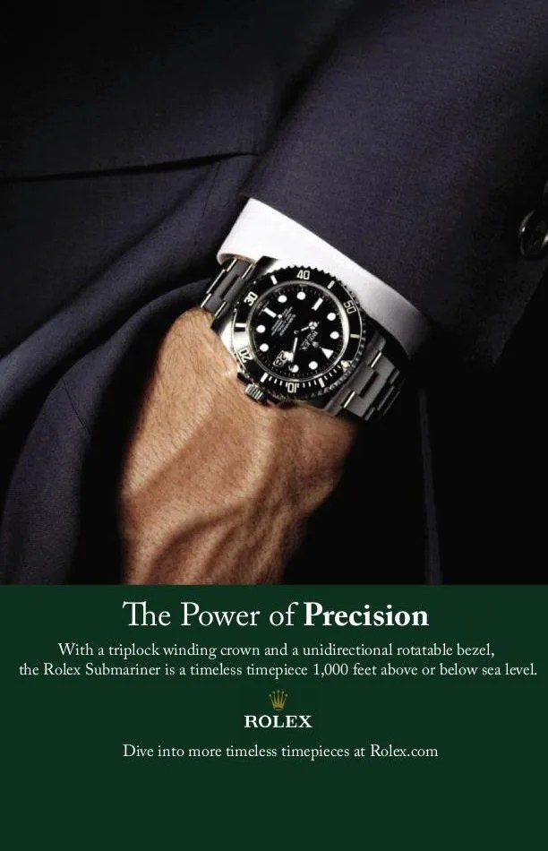 rolex submariner ad the power of precision with a triplock winding crown and a unidirecitonal rotatable bezel, the rolex submariner is a timeless timepiece 1,000 feet above or below sea level