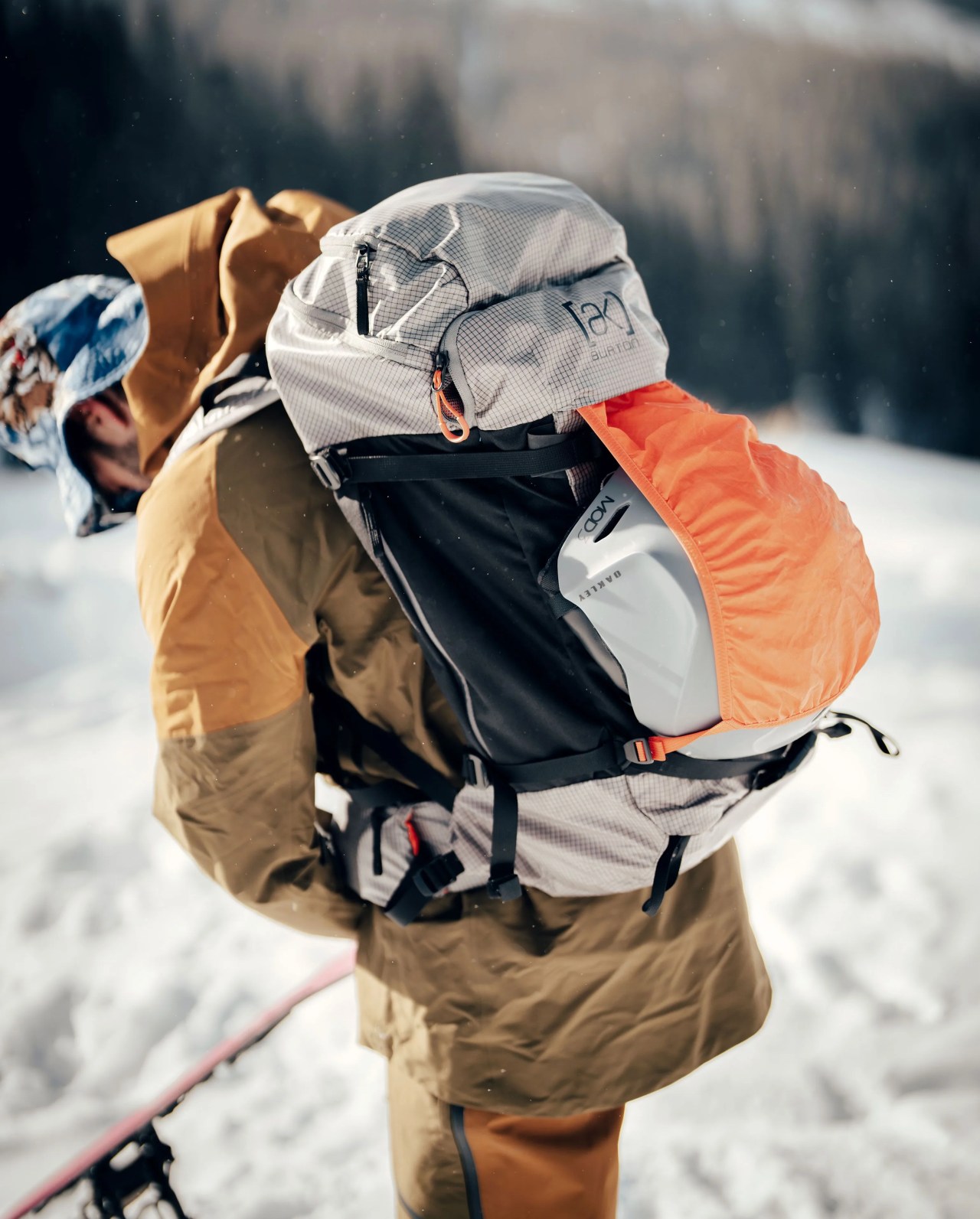 man wearing backpack in snow