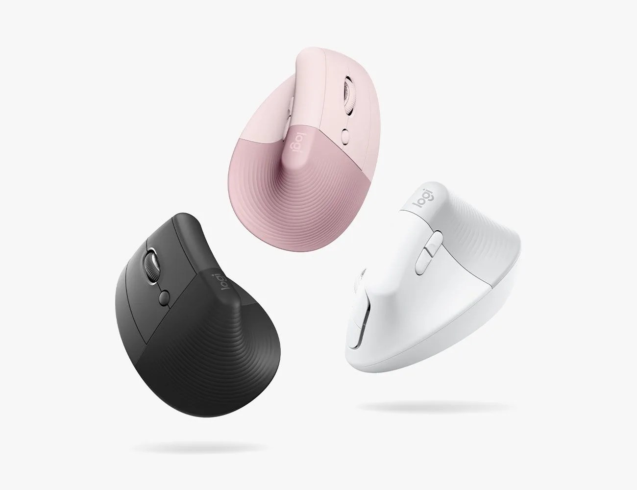 black logitech mouse floating next to the left of a pink logitetch mouse, white logitech mouse on the right