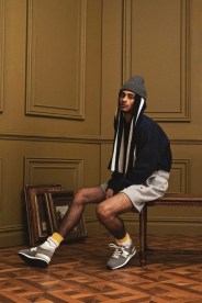 model sitting in a chair wearing new balance made in usa