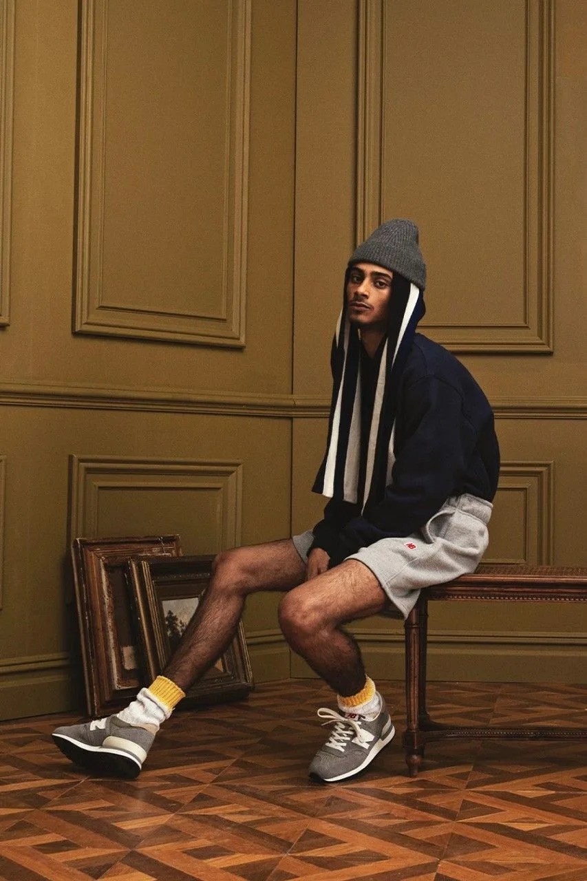 model sitting in a chair wearing new balance made in usa