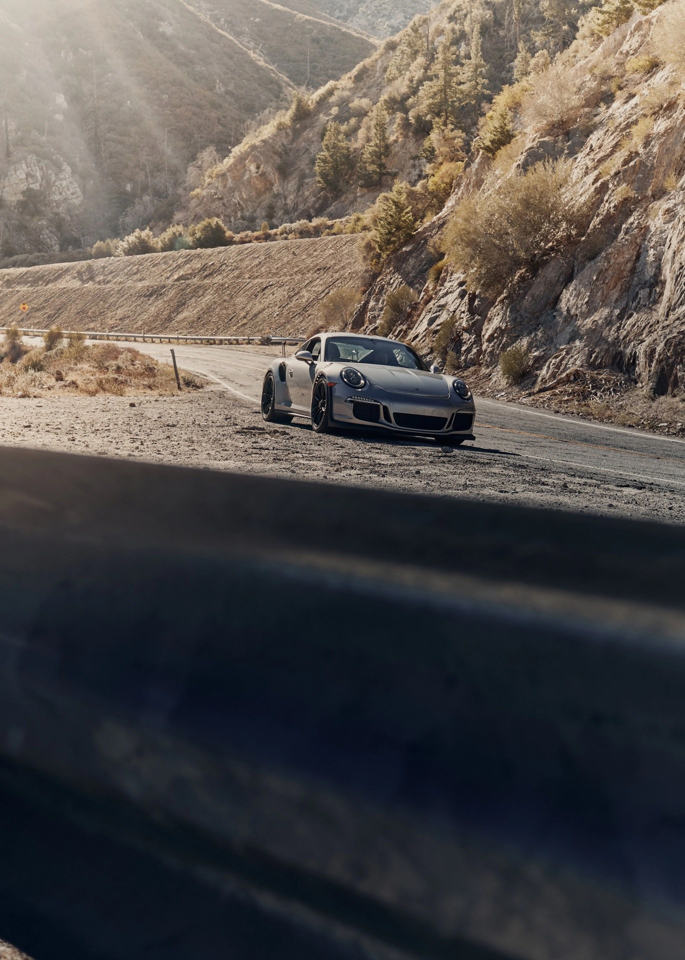 silver porsche driving on the road