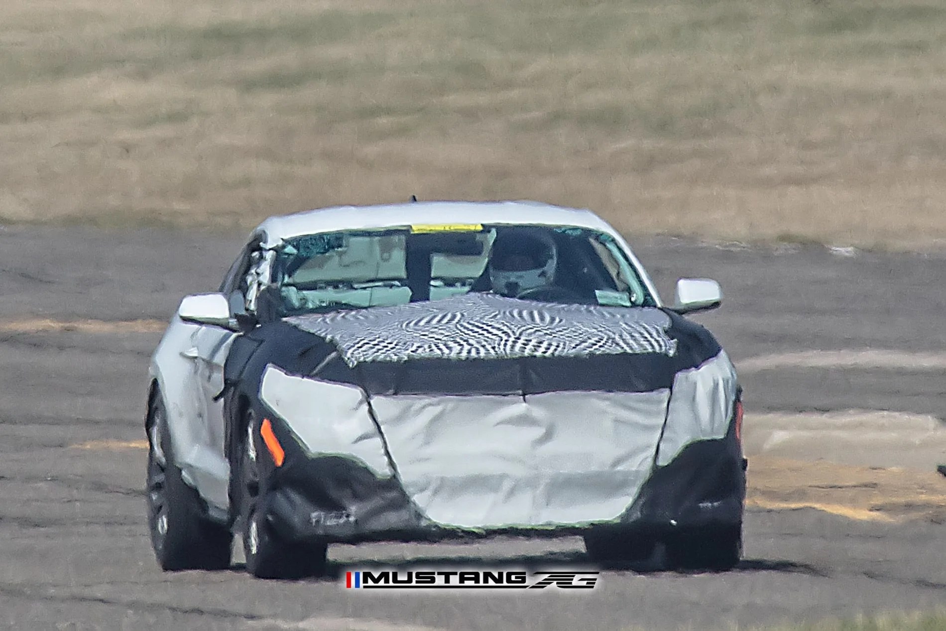 spy shot of camouflaged mustang test vehicle on track