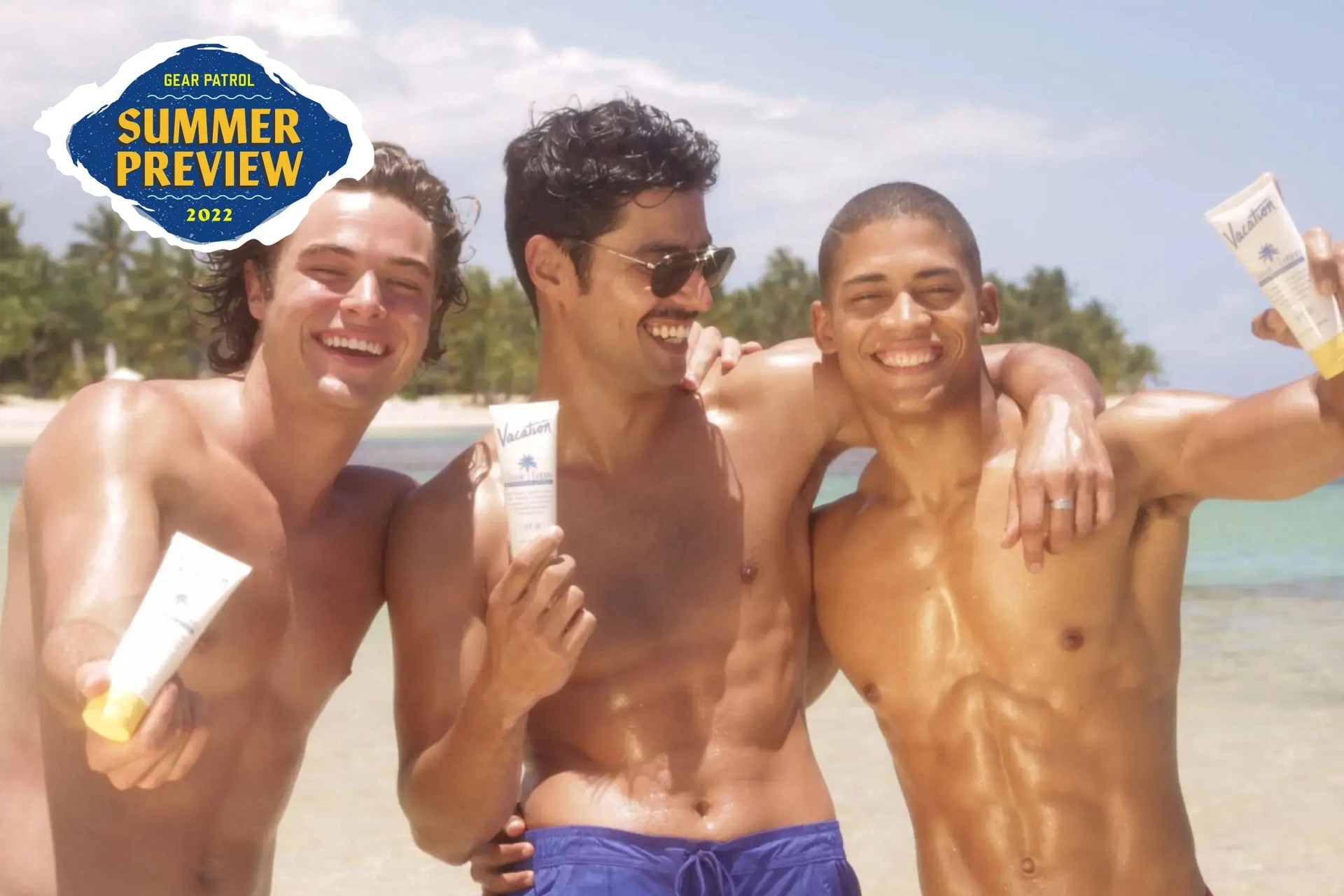 men holding vacation sunscreen at beach