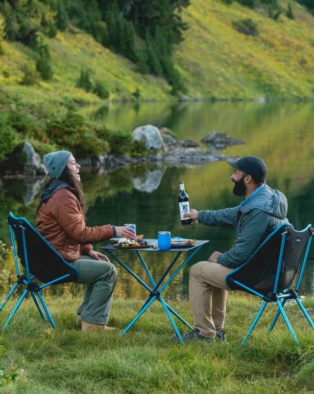 two people sitting on helinox cafe chair